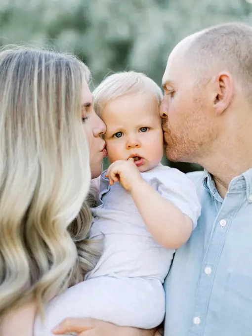 Parents kissing baby boy son