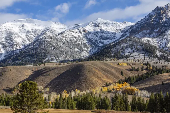 United States, Idaho, Sun Valley, Landscape with snowcapped Rocky Mountains and autumn forests in valleys