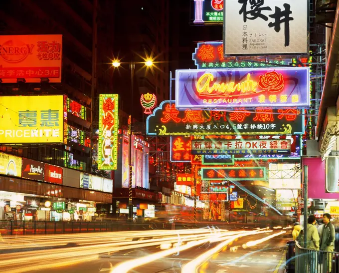 China, Hong Kong, Neon lights and signs on busy city street at night