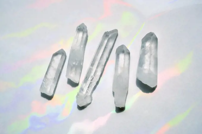 Transparent quartz crystals with rainbow light background