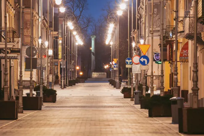 Poland, Holy Cross, Kielce, City street illuminated at night