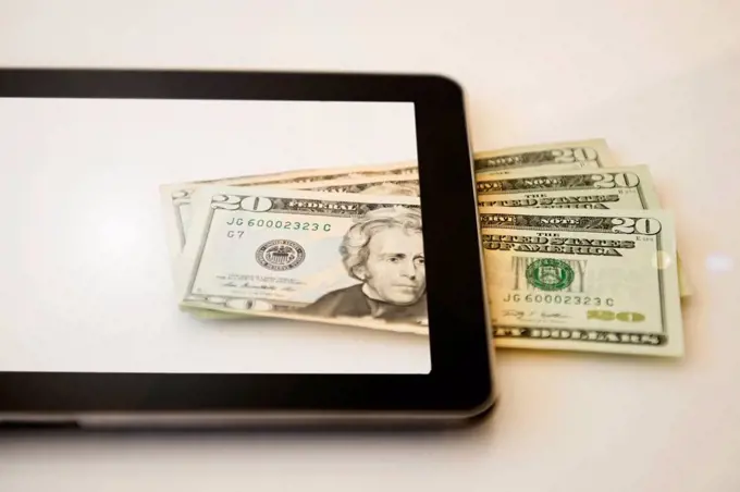 Digital tablet and twenty dollar bills