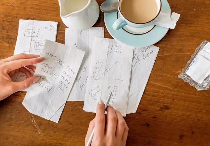 Woman writing on napkins