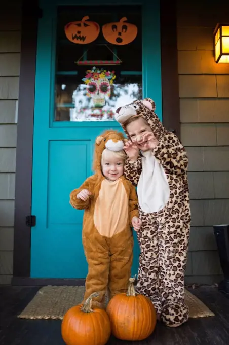 Two kids (2-3, 4-5) wearing Halloween costumes