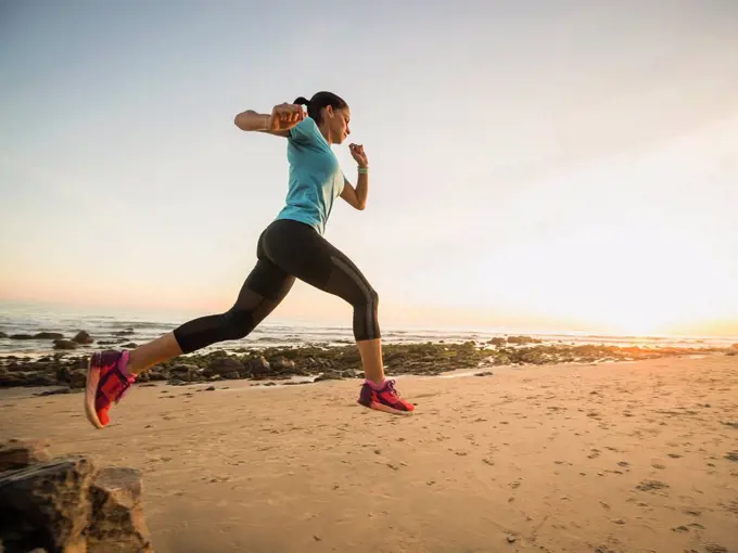 USA, California, Newport Beach, Woman jogging on beach