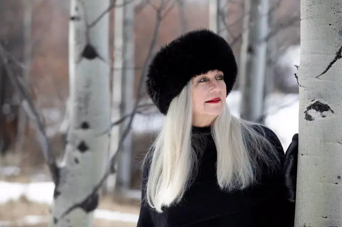 Woman with ushanka in forest