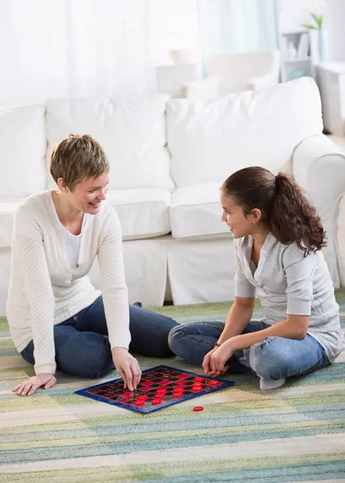 Mother and daughter playing checkers