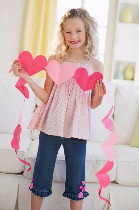 Young girl holding heart cut outs