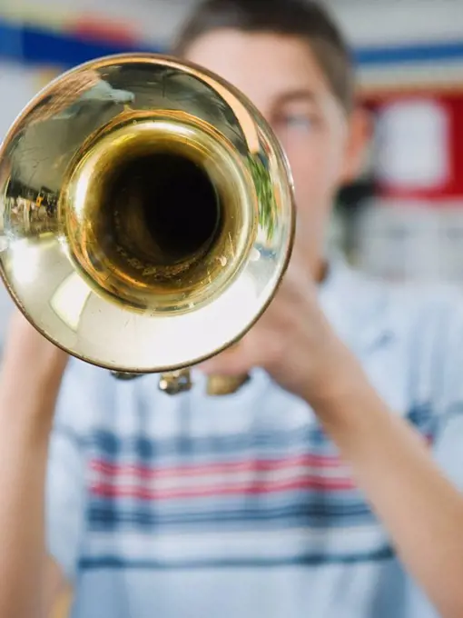Elementary school student playing trumpet