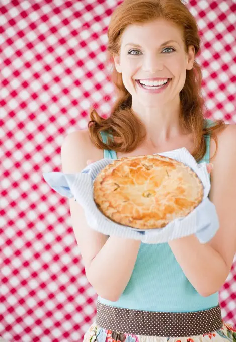 Woman holding a freshly baked pie