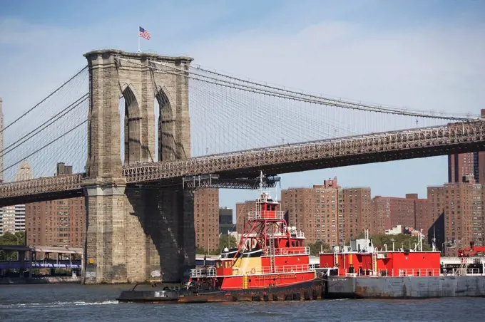 USA, New York State, New York City, Barge under Brooklyn Bridge