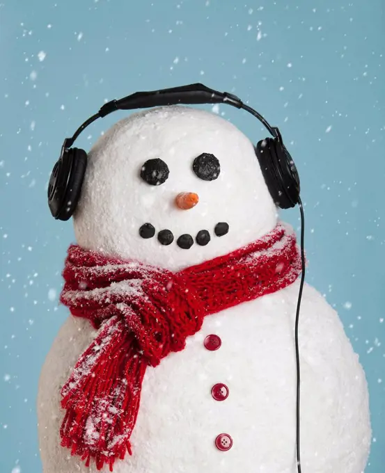 Studio shot of snowman wearing headphones