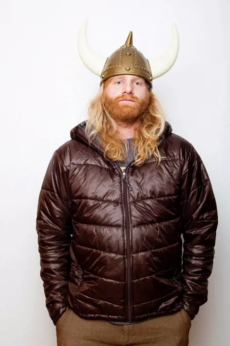 Studio Shot portrait of young man in Viking Helmet