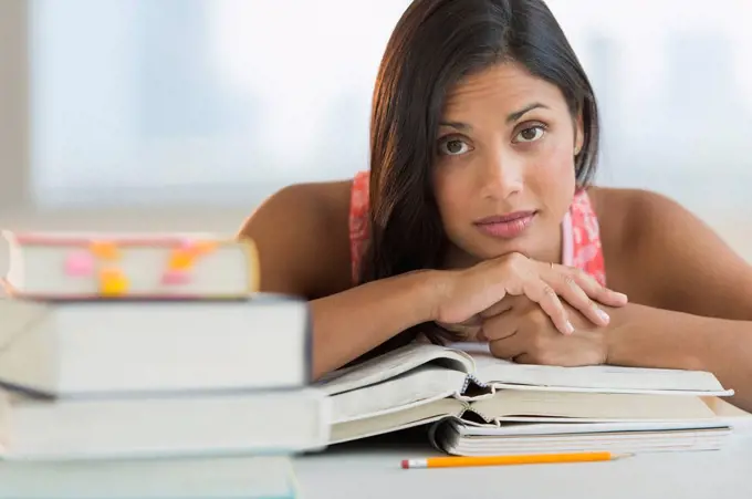 Female student leaning on books