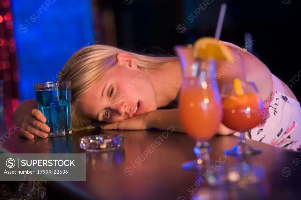 Drunk young woman passed out in bar