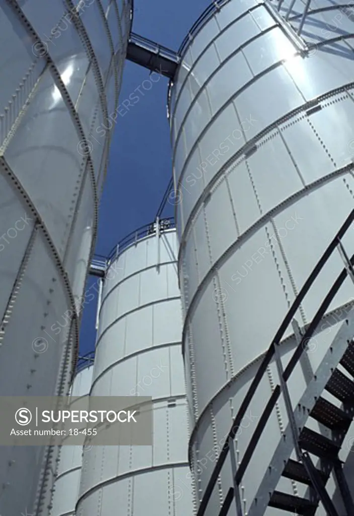 Low angle view of oil storage tanks
