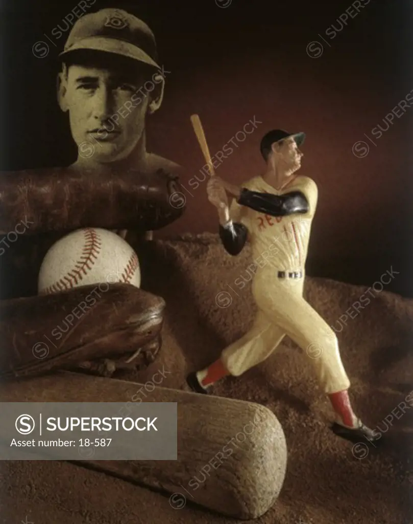 Close-up of a figurine of a baseball player with baseball memorabilia