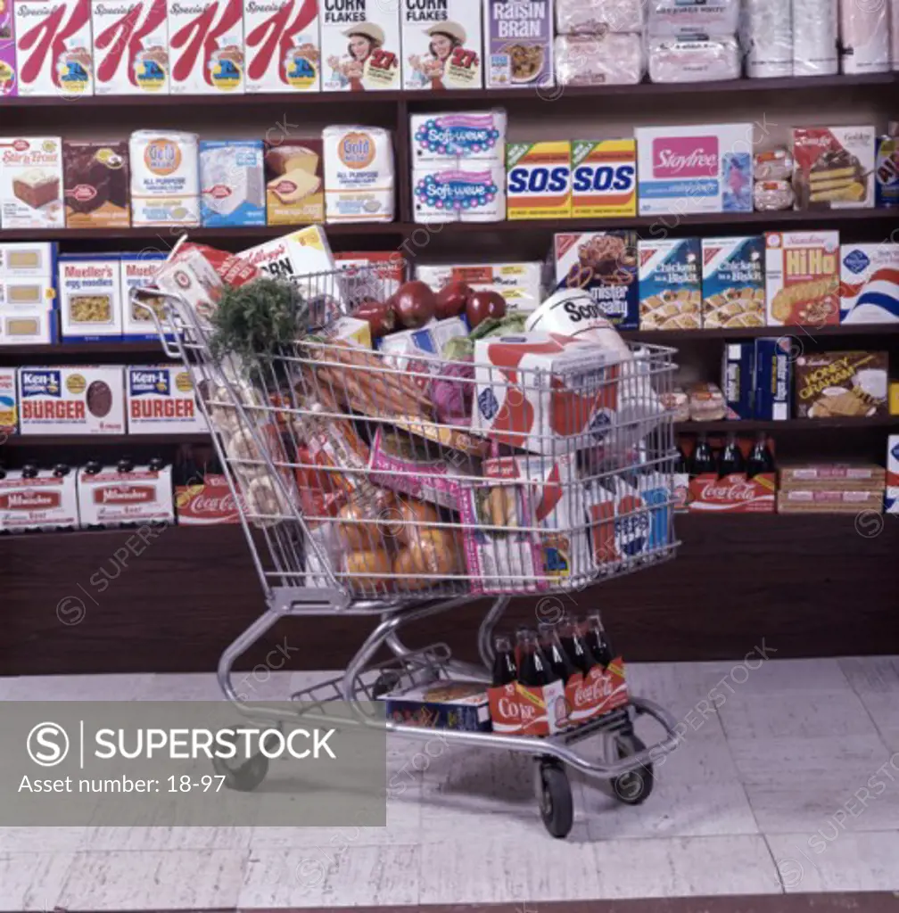 Shopping cart full of groceries in a supermarket