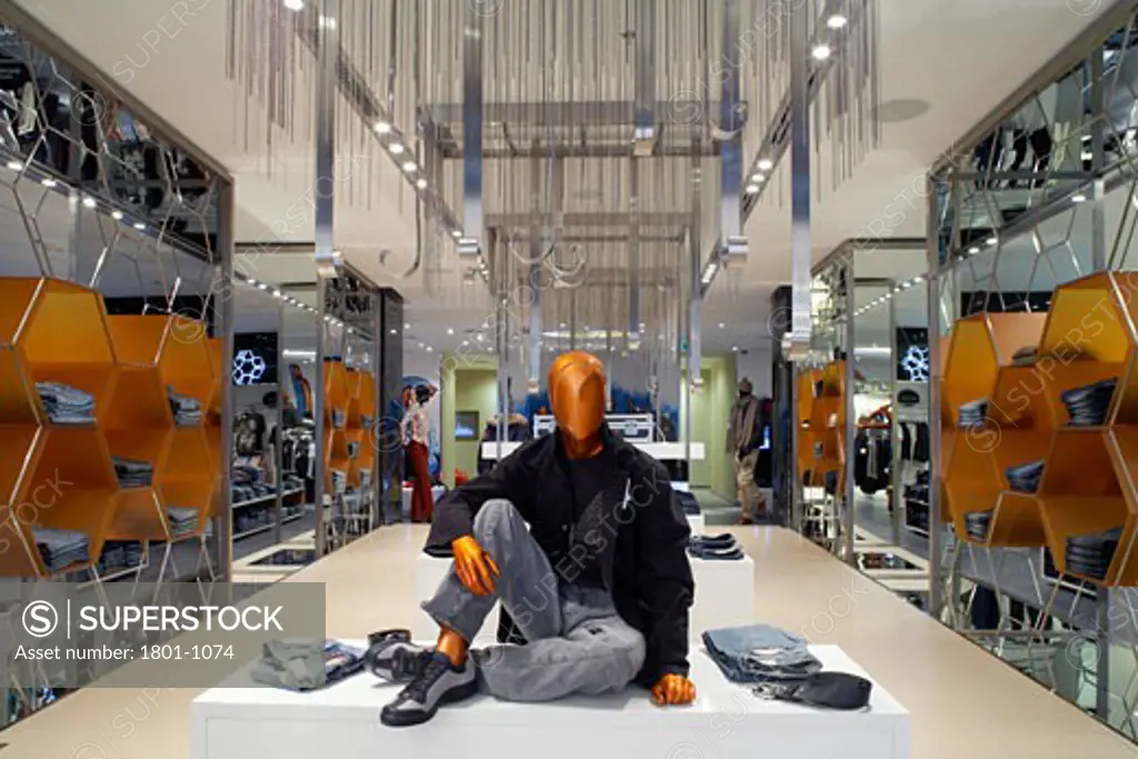 HARVEY NICHOLS DEPARTMENT STORE, KANYON SHOPPING MALL, ISTANBUL, TURKEY, INTERIOR OF THE MENS JEANSWARE DEPT ON THE LOWER GROUND FLOOR, WITH MANNIQUIN ON DISPLAY TABLE IN THE MIDDLE OF THE FRAME., FOUR IV DESIGN
