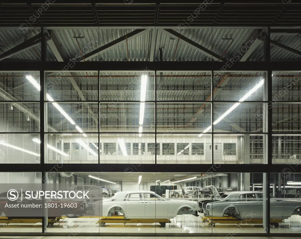 ROLLS-ROYCE MOTOR CARS LIMITED, THE DRIVE, WESTHAMPNETT, CHICHESTER, WEST SUSSEX, UNITED KINGDOM, NIGHT VIEW LOOKING AT PAINT SHOP WITH BARE RR CHASSIS, GRIMSHAW