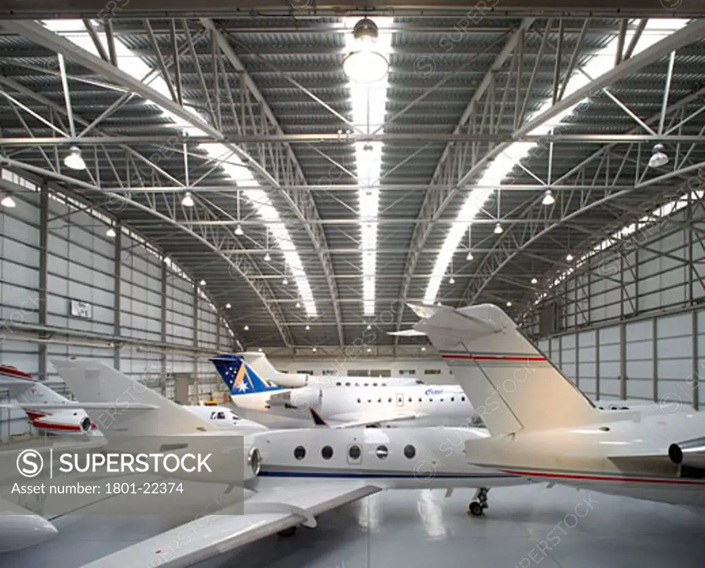 TAG AVIATION AIRPORT, FARNBOROUGH, HAMPSHIRE, UNITED KINGDOM, SYMETRICAL VIEW OF HANGAR AND JETS, REID ARCHITECTURE