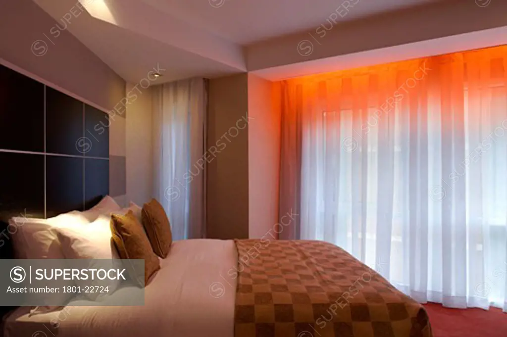 RIVERBANK HOTEL, VAUXHALL, LONDON, SE1 SOUTHWARK + BERMONDSEY, UNITED KINGDOM, VIEW OF BEDROOM WITH RED LIGHTING., RENTON HOWARD WOOD LEVIN