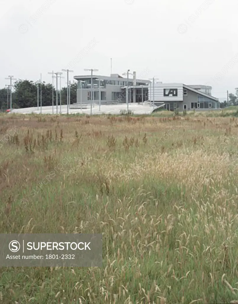LETTERKENNY AREA OFFICES, LETTERKENNY, DONEGAL, IRELAND, VIEW FROM WEST WITH GRASSES, MACGABHANN ARCHITECTS