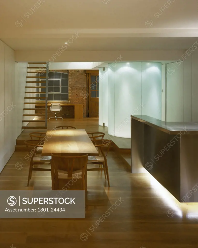 PENTHOUSE FLAT, UNITED KINGDOM, PORTRAIT VIEW AT NIGHT LOOKING PAST TABLE, STAIRS AND SHOWERPOD, SIMON CONDER ASSOCIATES