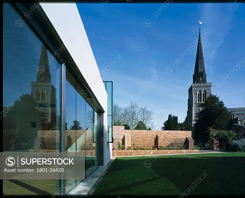 ST MARYS CHURCH HALL, ARTHUR ROAD, LONDON, SW19 WIMBLEDON, UNITED KINGDOM, VIEW OF HALL AND ORIGINAL GDII LISTED ST MARYS CHURCH FROM ‘EXTERNAL ROOM SUNKEN GARDEN. GDII LISTED RED BRICK WALL VISIBLE, TERRY PAWSON ARCHITECTS