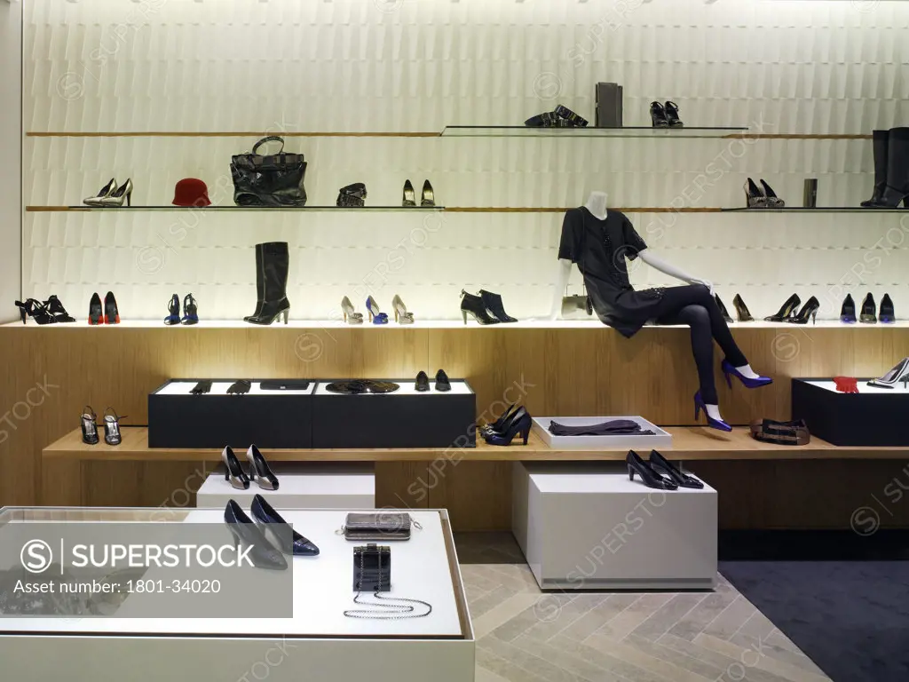 Reiss flagship store ground floor womens accessories area with accessories wall display in the background and display units in the foreground., Reiss Flagship Store, Barrett Street, London, W1 Oxford Street, United Kingdom, Universal Design Studio