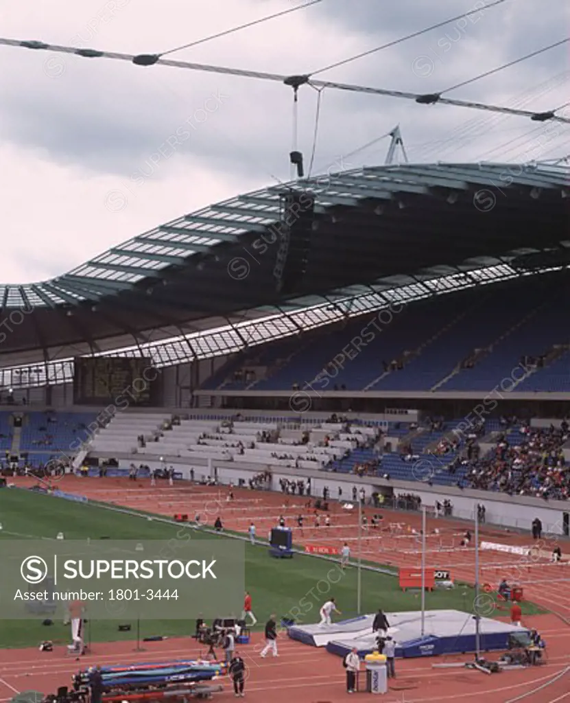 CITY OF MANCHESTER STADIUM, MANCHESTER, UNITED KINGDOM, STADIUM INTERIOR WITH ATHLETES FROM TEMPORARY STAND (100M HURDLES), ARUP ASSOCIATES