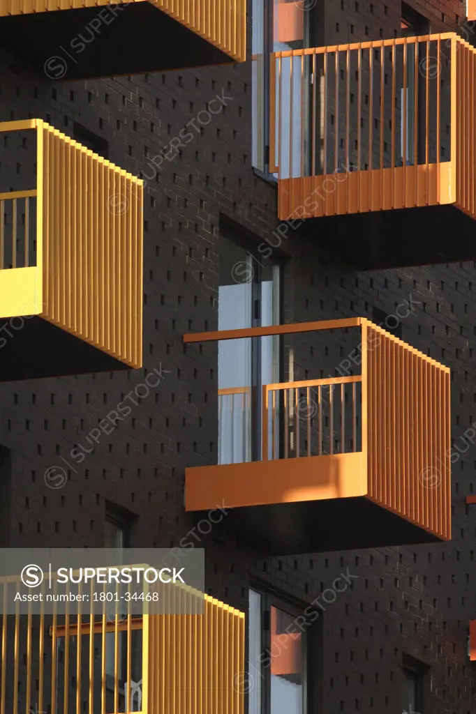 Barking Learning Centre and Apartments, London, United Kingdom, Ahmm Allford Hall Monaghan Morris Llp, Barking central apartments yellow and orange balconies against dark brick facade.