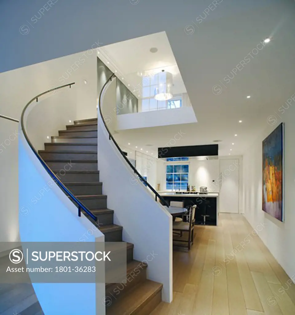 Private House, London, United Kingdom, Brenton Smith, Private house kensington spiral staircase with kitchen beyond.