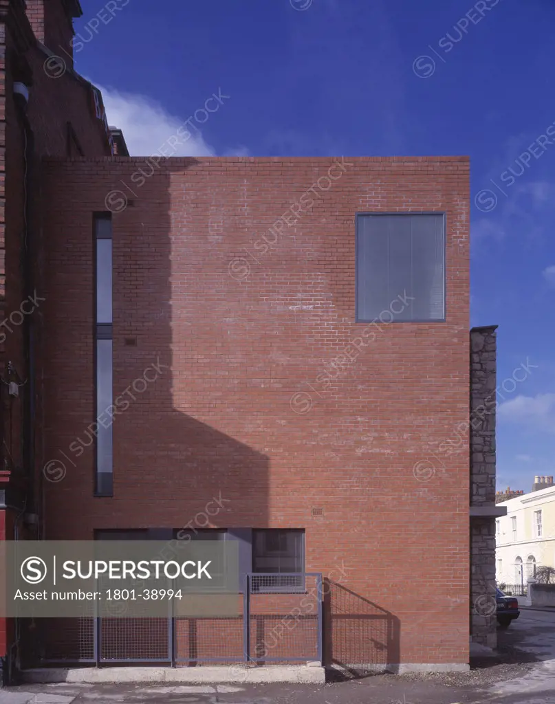 Private House, Dublin, Ireland, Grafton Architects, Private house street elevation brick facade with shadow.
