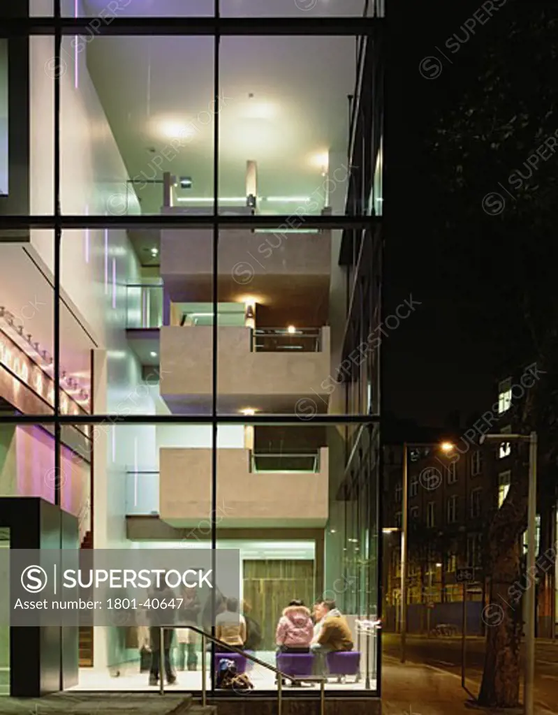 Unicorn Theatre, London, United Kingdom, Keith Williams Architects, Unicorn theatre lobby at night with cantilevered concrete stair.