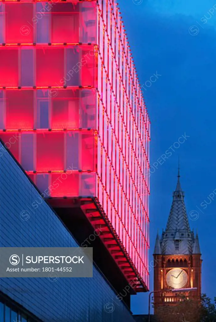 University of Liverpool Faculty of Engineering, Liverpool, United Kingdom, Sheppard Robson, University of liverpool faculty of engineering a dramatic close up shot of the glass building lit by night with a view to the tower and clock.