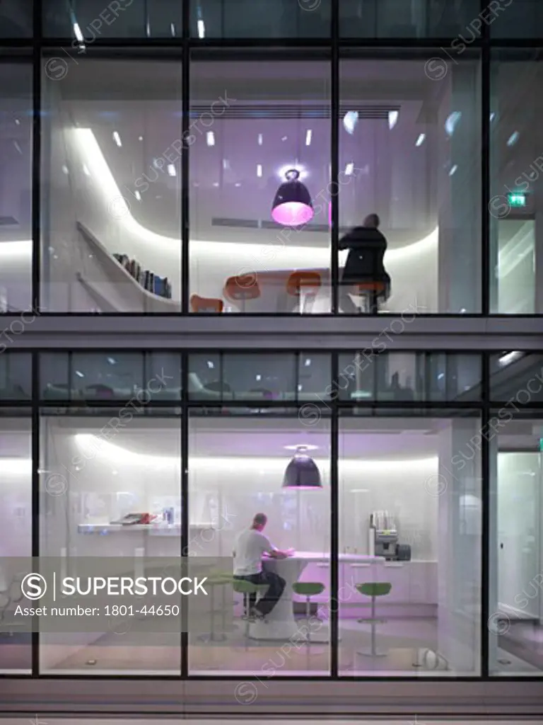 Hammerson, London, United Kingdom, Stiff and Trevillion Architects, Hammerson detail of meeting rooms through glass walls night shot pink lights modern office.