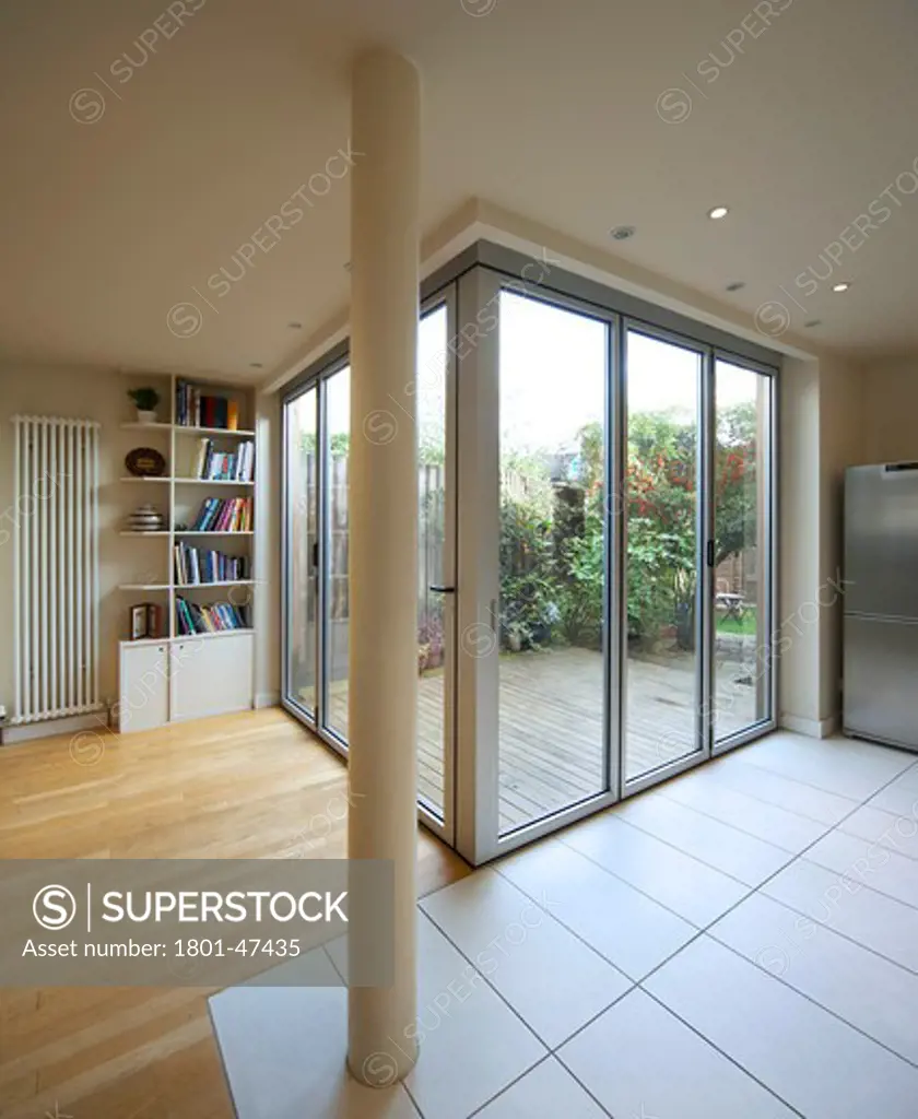 Private House, London, United Kingdom, Archicraft, PRIVATE HOUSE ARCHICRAFT ROB MATHISON SOUTH WOODFORD LONDON UK 2009. INTERIOR VIEW OF THE CLOSED GLASS FEATURE DOORS WITH A VIEW OUT TO THE GARDEN