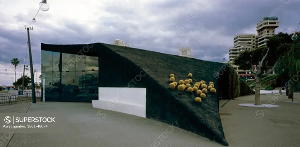 Plaza De España, Santa Cruz De Tenerife, Spain, Herzog & De Meuron, VIEW OF A SMALL BUILDING WHICH IS THE HIDDEN ENTRANCE TO THE UNDERGROUND CAR PARK USING LOCAL VOLCANIC STONES FOR THE ROOFING AS WELL AS ORNAMENTAL LOCAL FLORA