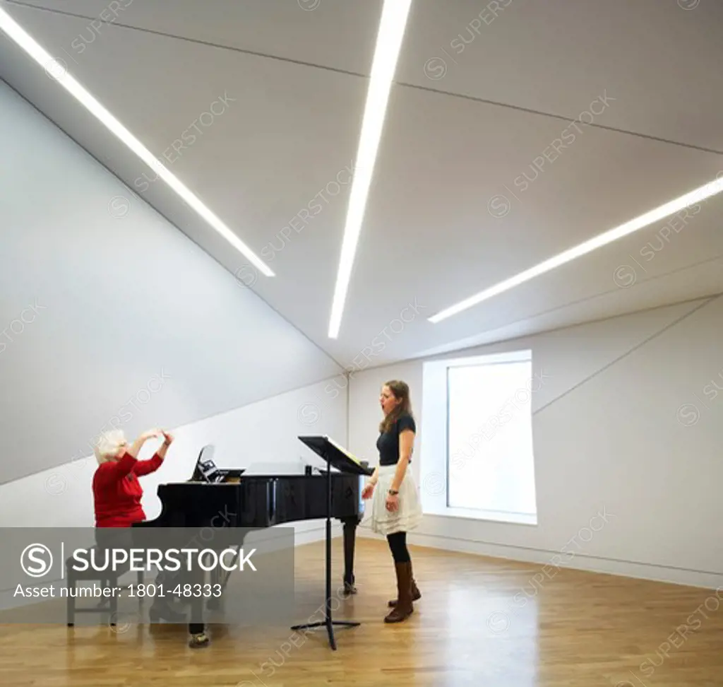Royal Academy of Music, London, United Kingdom, John McAslan and Partners, ROYAL ACADEMY OF MUSIC JOHN MCASLAN & PARTNERS 2002. INTERIOR SHOT OF A PRACTICE ROOM SHOWING A PIANIST AND SINGER REHEARSING