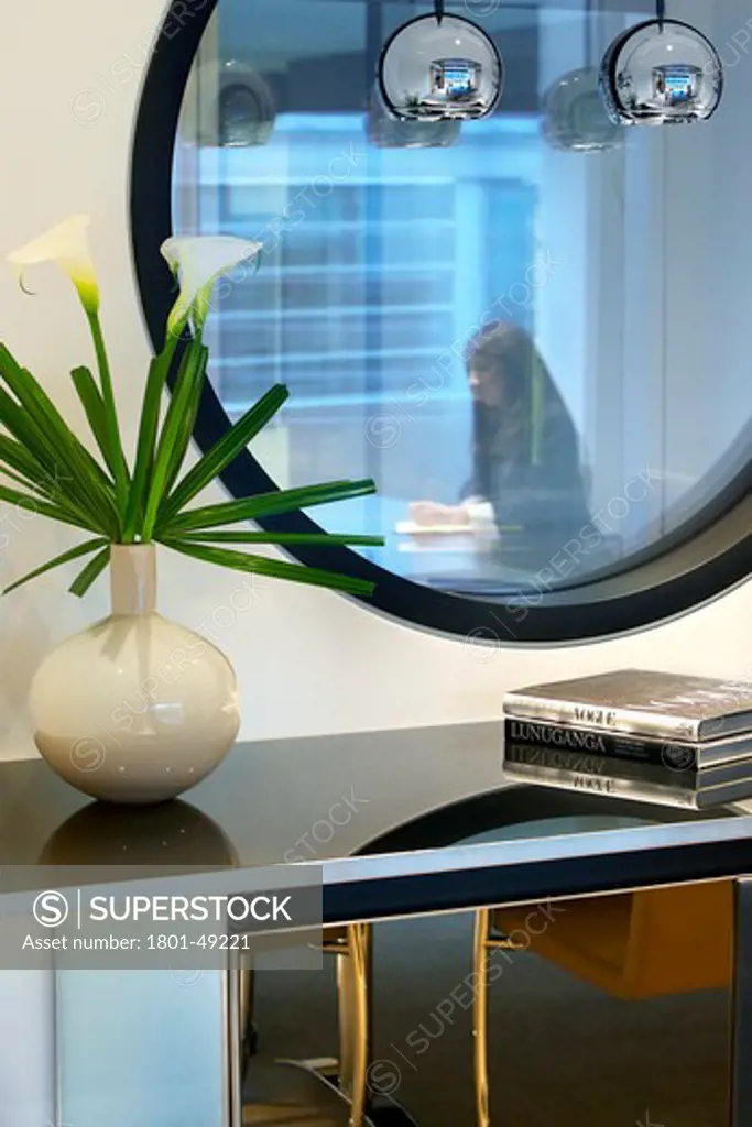 Orrick, London, United Kingdom, Tp Bennett, ORRICK HERRINGTON & SUTCLIFFE TP BENNETT LONDON UK 2009. INTERIOR SHOT OF A TABLE AND FLOWER ARRANGEMENT WITH A VIEW TO A WOMAN WORKING AT A DESK
