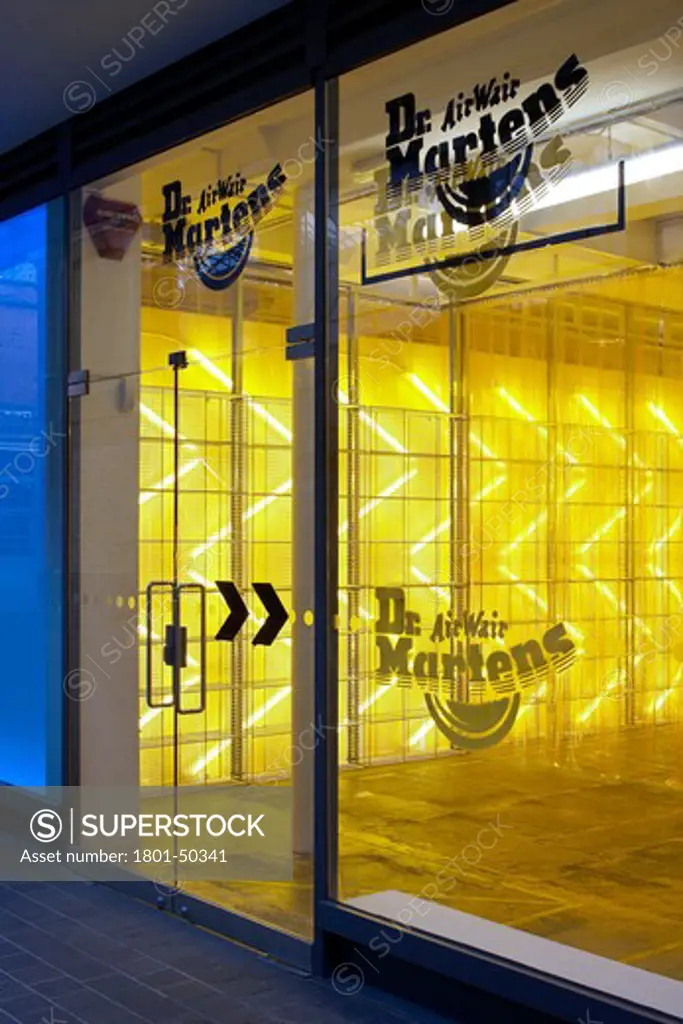 Dr Martens Pop up Store Spitalfields London, London, United Kingdom, Campaign Design, DR MARTEN POP-UP STORE CAMPAIGN DESIGN SPITALFIELDS LONDON UK 2009. EXTERIOR SHOT SHOWING THE DR MARTEN BRANDING ON THE WINDOW AND BOLD YELLOW LIGHTING INSIDE