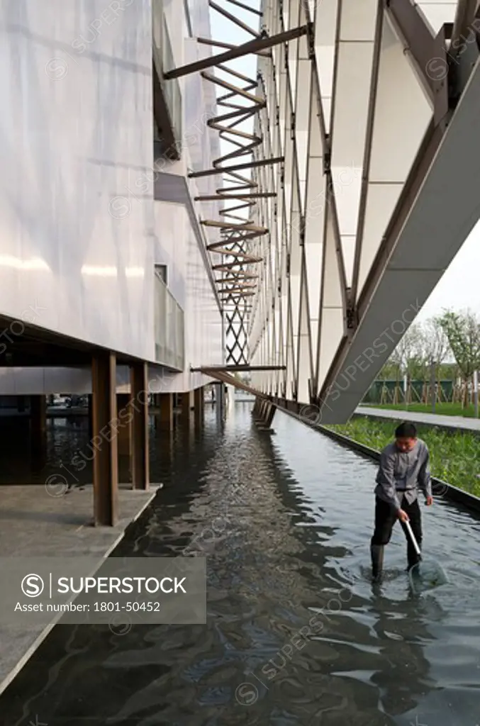 Shanghai Expo 2010 French Pavilion, Shanghai, China, Jacques Ferrier Architects, THE SENSUAL CITY FRENCH PAVILION JACQUES FERRIER ARCHITECTS WORLD EXPO 2010 SHANGHAI CHINA. MAN WORKING AT GROUND LEVEL WATER PIT