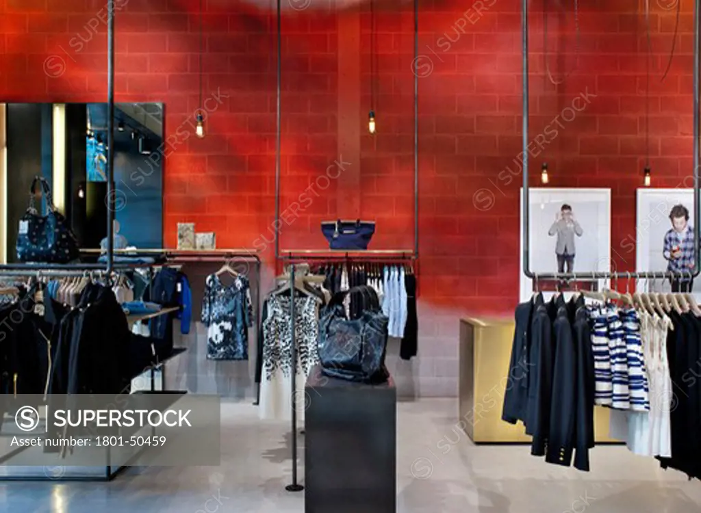 REISS STORE D-RAW CARDIFF 2010 VIEW OF RED WALL IN SHOP WITH HANGING DISPLAY OF CLOTHING