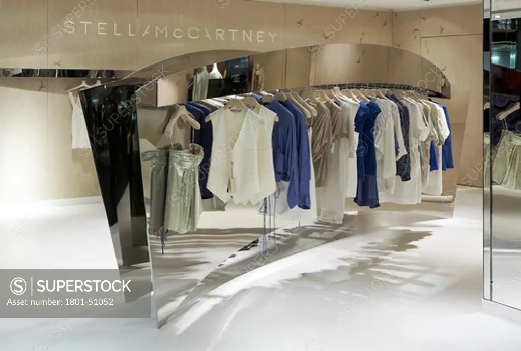 STELLA MCCARTNEY DEPARTMENT STORE UNIVERSAL LONDON 2008 VIEW OF MIRRORED DISPLAY WITH CLOTHING ON HANGING RAIL