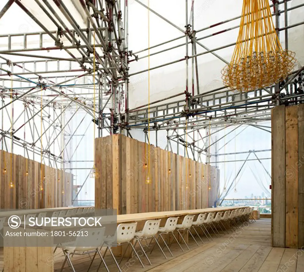 Studio East Dining Main Table With Scaffold Board Tables And Inspection Lamp Chandeliers.  Carmody Groarke Architects  London 2010.