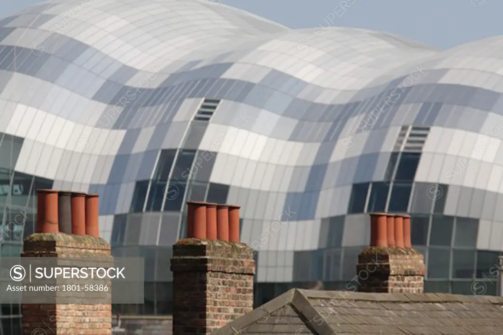 The Sage, Foster and Partners, Newcastle Gateshead Uk, 2004, Seen Over Rooftops With Chimney Stacks And Tiled Roofs
