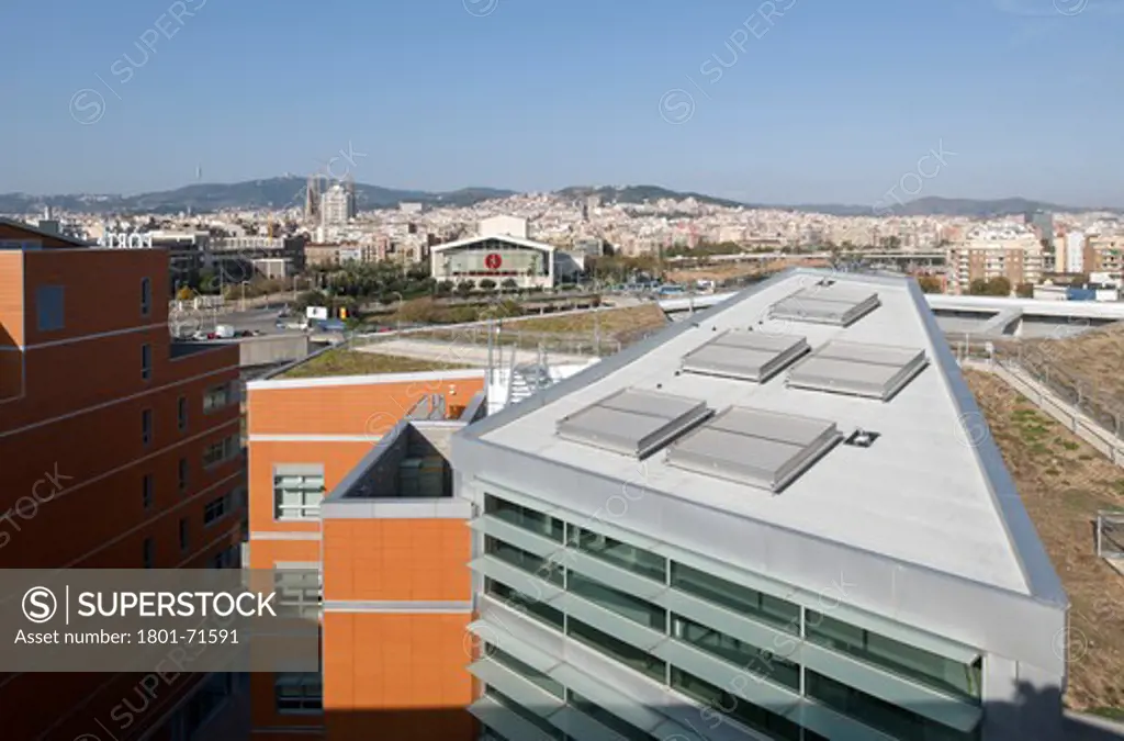 William Macdonough , Partners Ecourban Building Barcelona Poble Nou 22@ District General Exterior View Of Triangular Building Showing Chimney Doors  Roof Garden With City In The Background