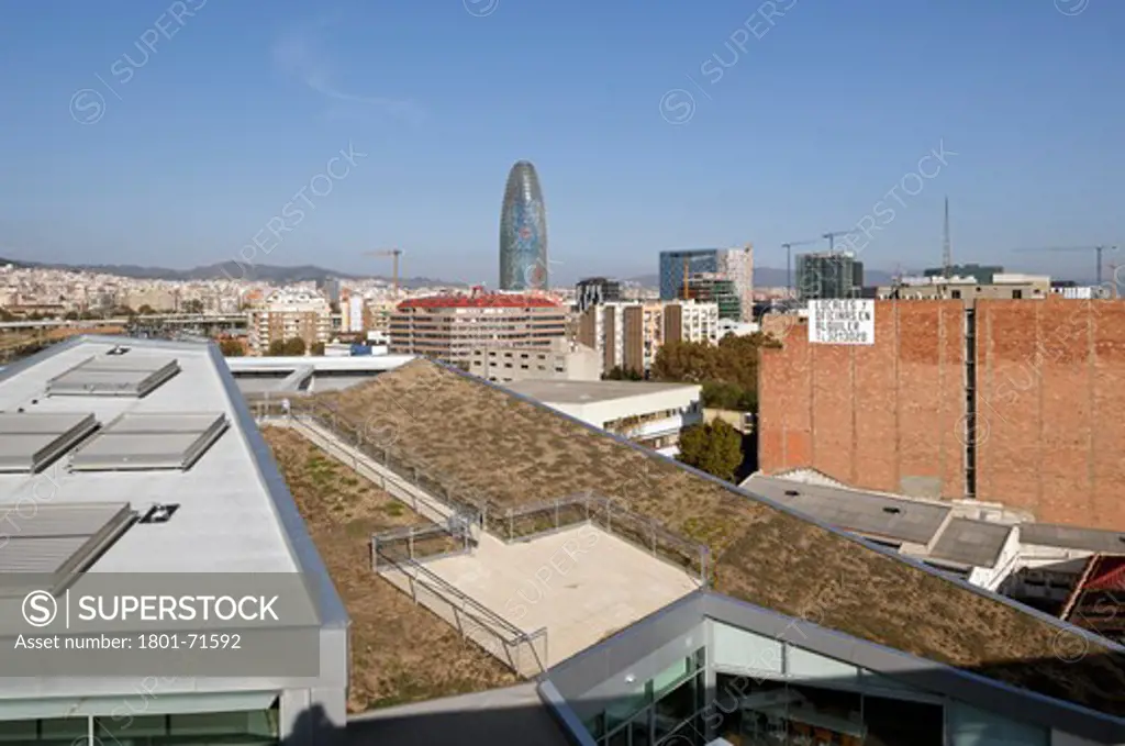 William Macdonough , Partners Ecourban Building Barcelona Poble Nou 22@ District L Exterior View Of Triangular Building Showing Chimney Doors  Roof Garden With City In The Background