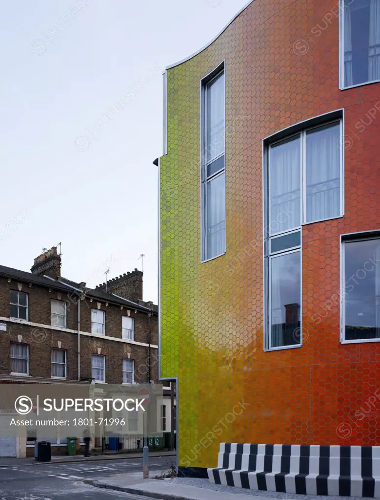 Brandon Street Housing, London, United Kingdom. Architect Metaphorm, 2012. Corner view of curved facade versus traditional terrace.